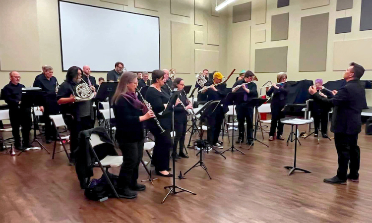 QCFB: In concert, standing playing the Ukrainian National Anthem.